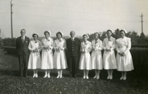 Nurses, doctors standing outdoors at the Provincial Training School.